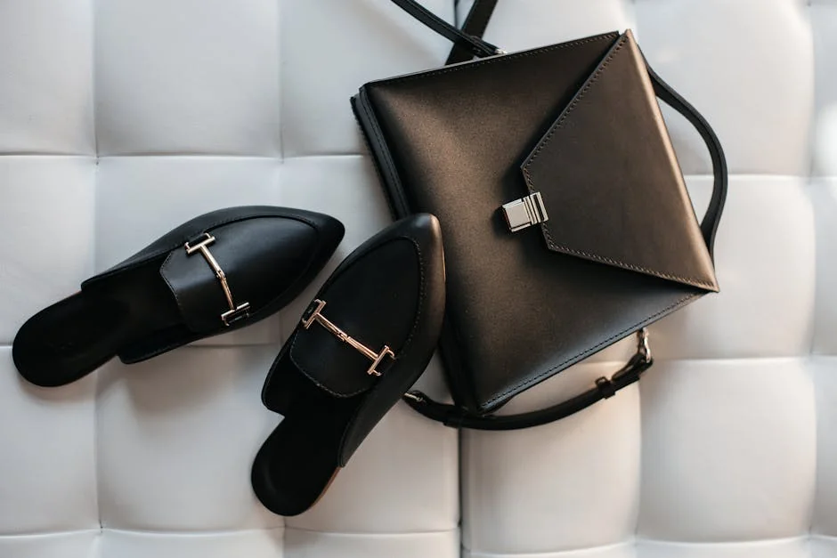 Elegant black leather handbag and shoes displayed on a stylish white background. - affordable luxury daily goods that feel highend
