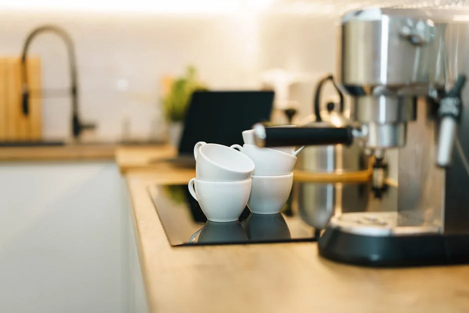 A modern espresso machine with coffee cups on a kitchen counter, showcasing a cozy and inviting setup. - how to choose the right coffee maker for your morning routine