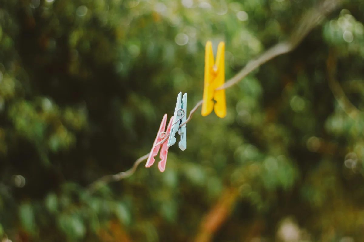 yellow blue and pink clothes pin - comparing the most popular ecofriendly laundry detergents