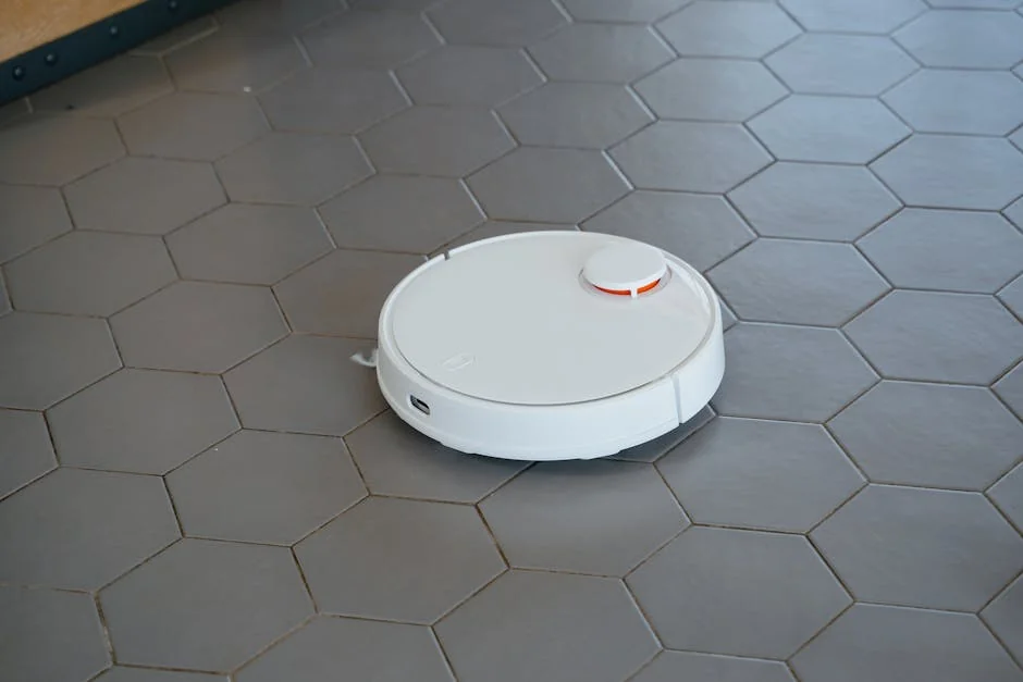 A sleek, white robotic vacuum cleaner operating on a hexagonal tiled floor. - comprehensive review of the latest smart home cleaning devices