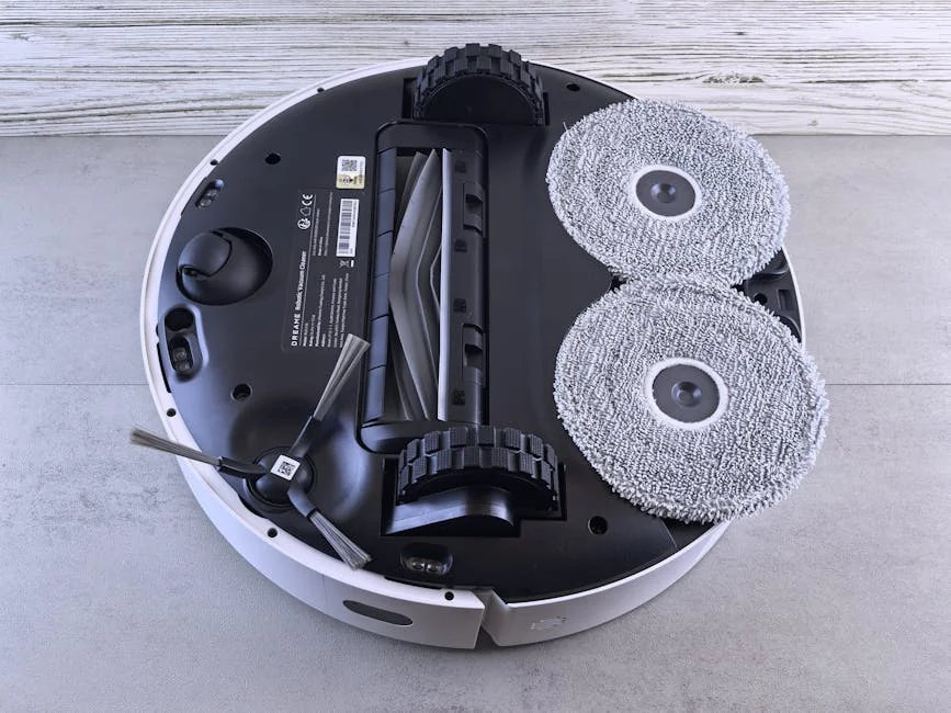 Detailed view of a robotic vacuum cleaner's underside showing brushes and wheels. - comprehensive review of the latest smart home cleaning devices