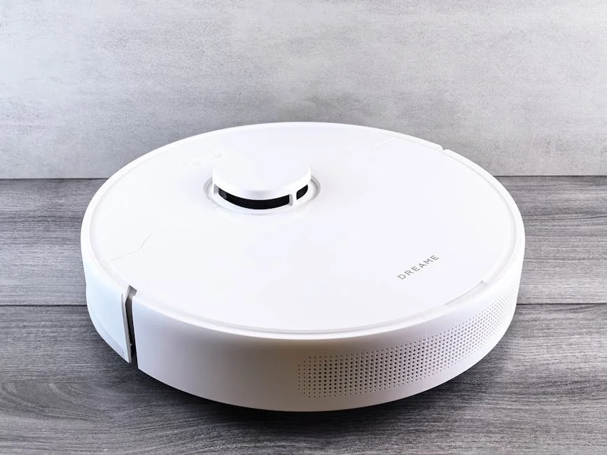 Sleek white robot vacuum cleaner on a wooden floor, perfect for smart home setups. - comprehensive review of the latest smart home cleaning devices
