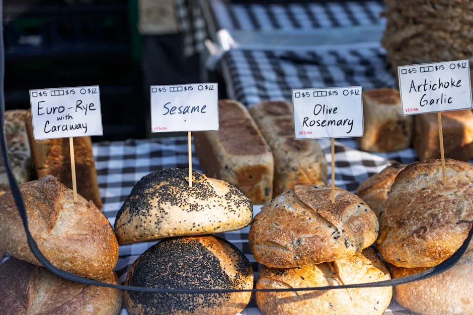 Assorted artisanal breads on display at a market stall, labeled with prices and ingredients. - discovering highquality artisanal daily goods at fair prices