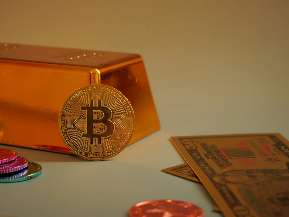 Bitcoin coin with gold bar and currency notes. - financial growth portfolio - Are expensive daily products worth the investment