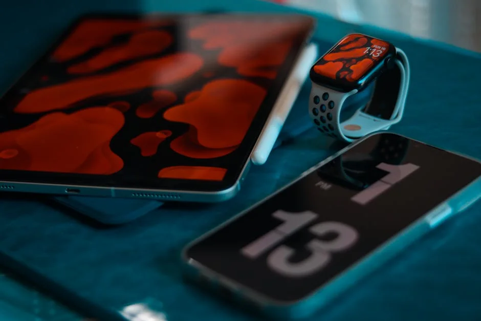 A collection of modern tech gadgets including a smartphone, smartwatch, and tablet, creatively displayed. - factors to consider before upgrading your daily tech gadgets