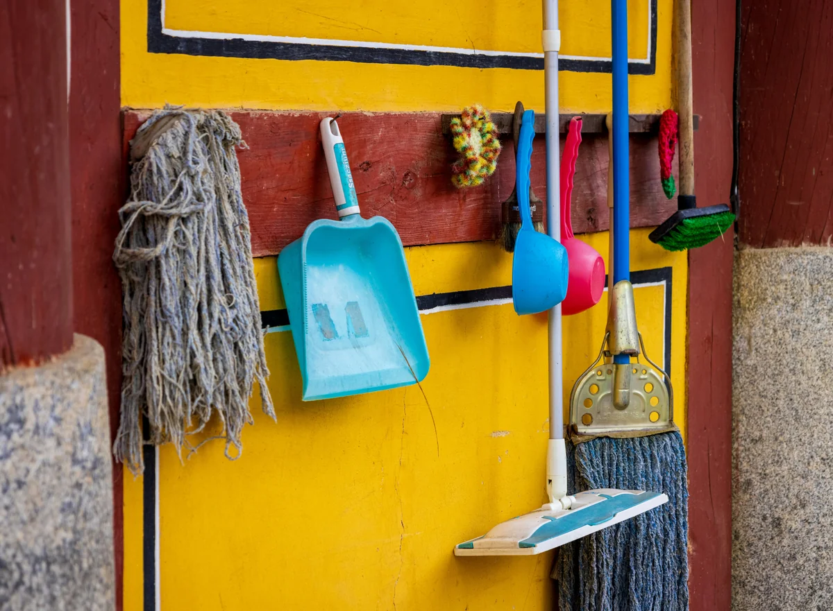 a yellow wall with a blue and white towel from it - highperformance cleaning tools for busy professionals