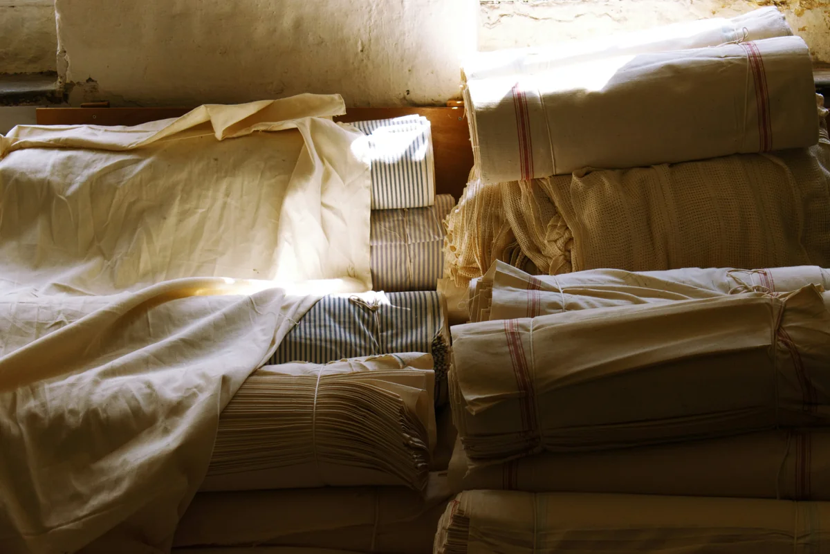 Pile of cottons and linens captured as the natural sunlight crept in through the window. I loved the rich, warm tones and shadows cast. Armley Mills in Leeds, West Yorkshire - what to look for when purchasing highquality bed linens