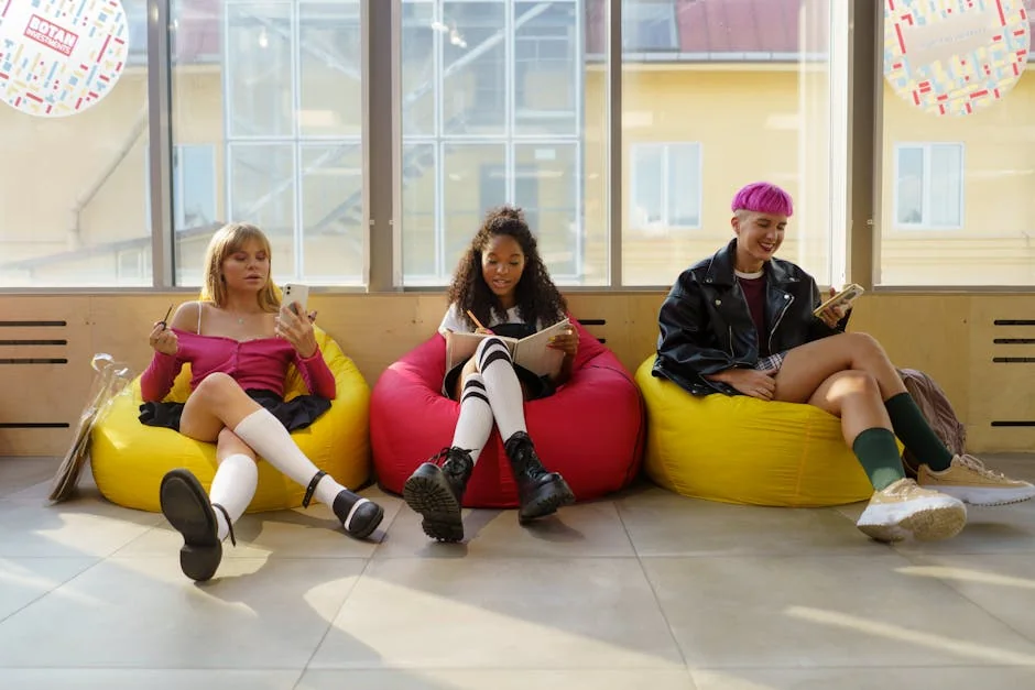 Three teenagers relaxing in colorful bean bags, enjoying leisure time indoors. - musthave daily goods for college students in dorms