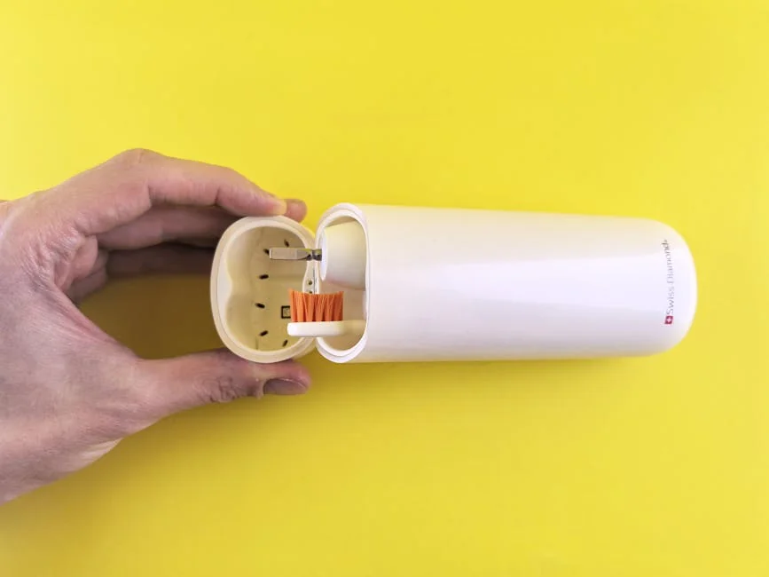 A stylish portable electric toothbrush with a sleek protective case against a vibrant yellow backdrop. - performance analysis of the top electric toothbrushes