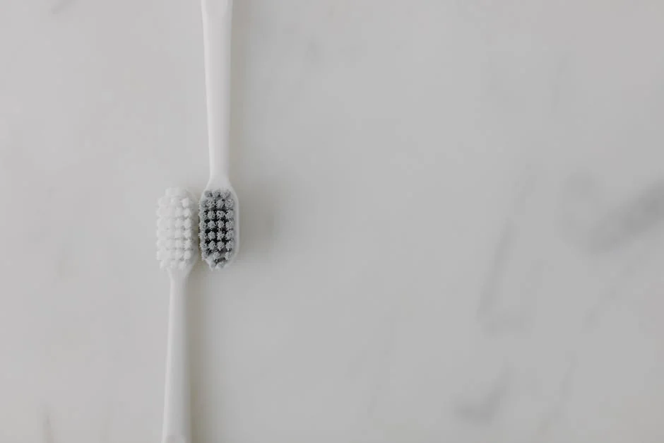 A minimalist image of two toothbrushes with contrasting bristles on a marble background, ideal for dental care themes. - performance analysis of the top electric toothbrushes