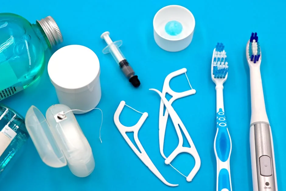 A variety of dental hygiene tools arranged neatly on a vibrant blue surface, showcasing oral care essentials. - performance analysis of the top electric toothbrushes