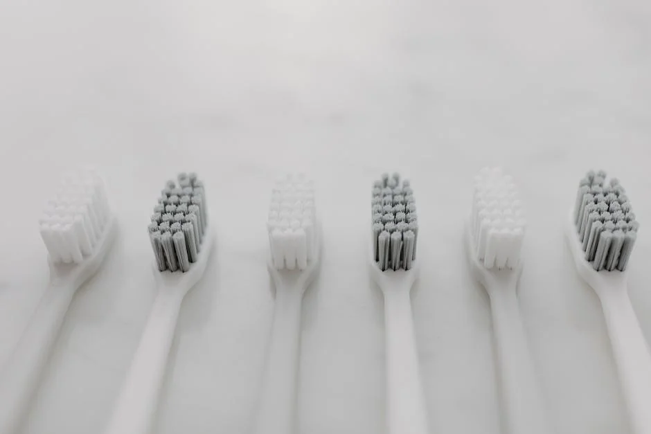 A clean and minimalist flat lay of toothbrushes on a marble surface for oral hygiene. - performance analysis of the top electric toothbrushes