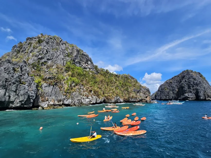 A vibrant scene of kayakers exploring the limestone cliffs in El Nido, Philippines. - adventure vacation destination - Rare and useful travel essentials for frequent commuters