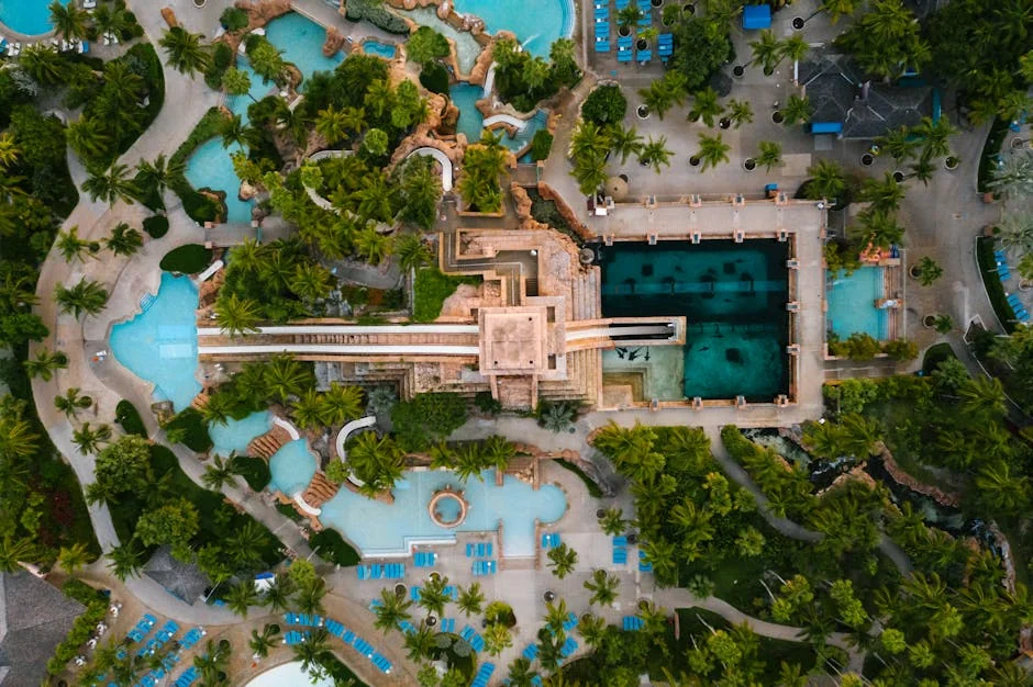 Stunning aerial view of a luxurious tropical resort featuring multiple pools and lush greenery. - adventure vacation destination - Rare and useful travel essentials for frequent commuters