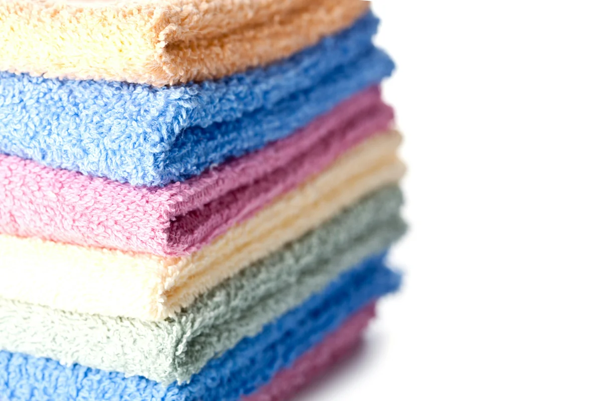 A stack of multicolored towels sitting on top of each other - how to spot highquality materials in everyday household goods