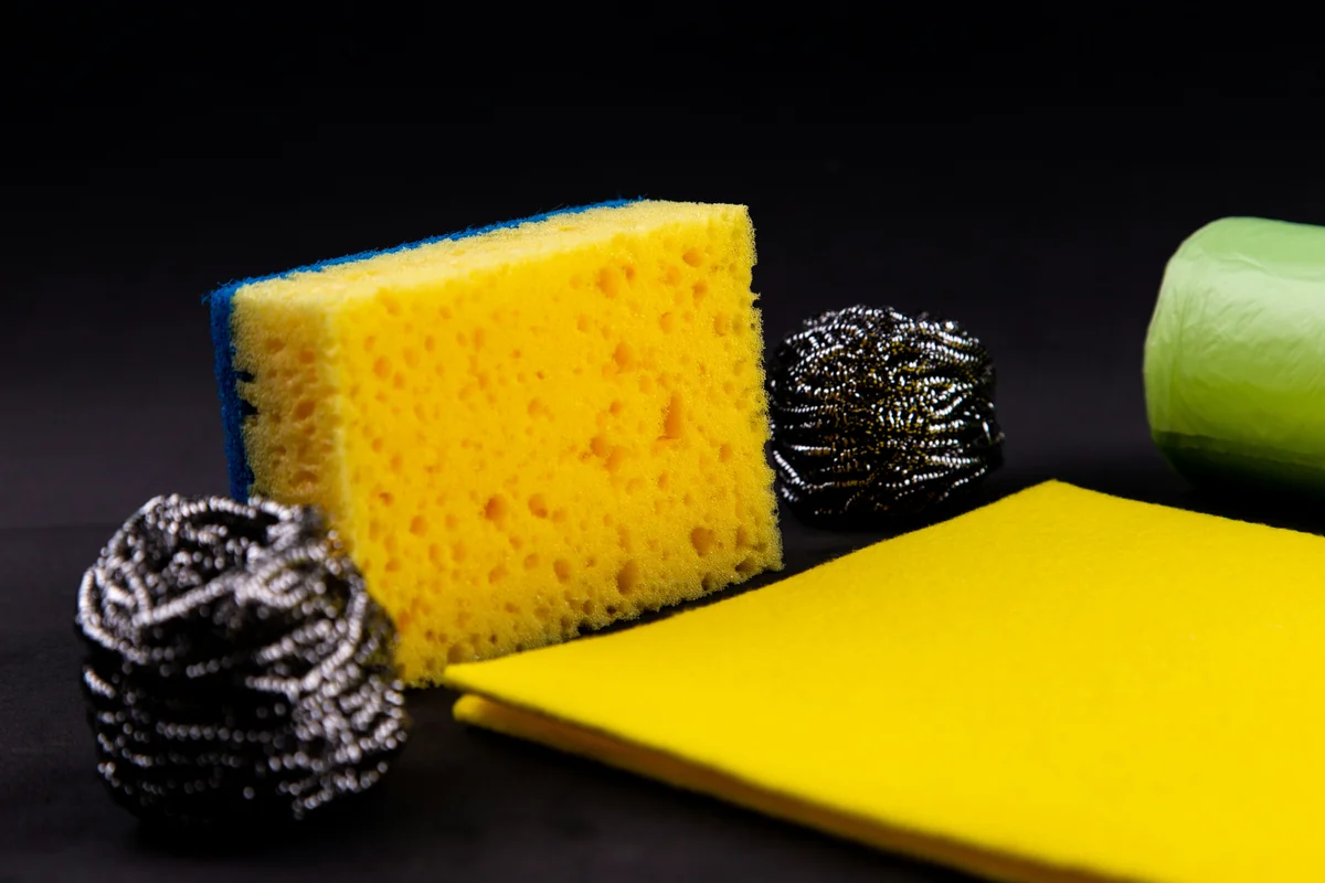 Dishwashing concept. On a black background, different washcloths and scrubbers for washing dishes - how to spot highquality materials in everyday household goods