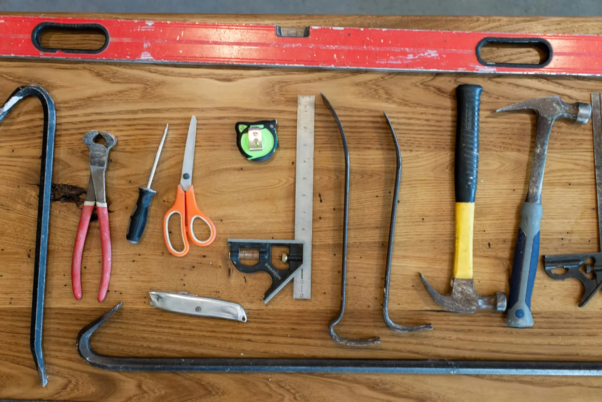 assorted hand tools on brown wooden table - the ultimate list of lifeimproving household hacks and tools
