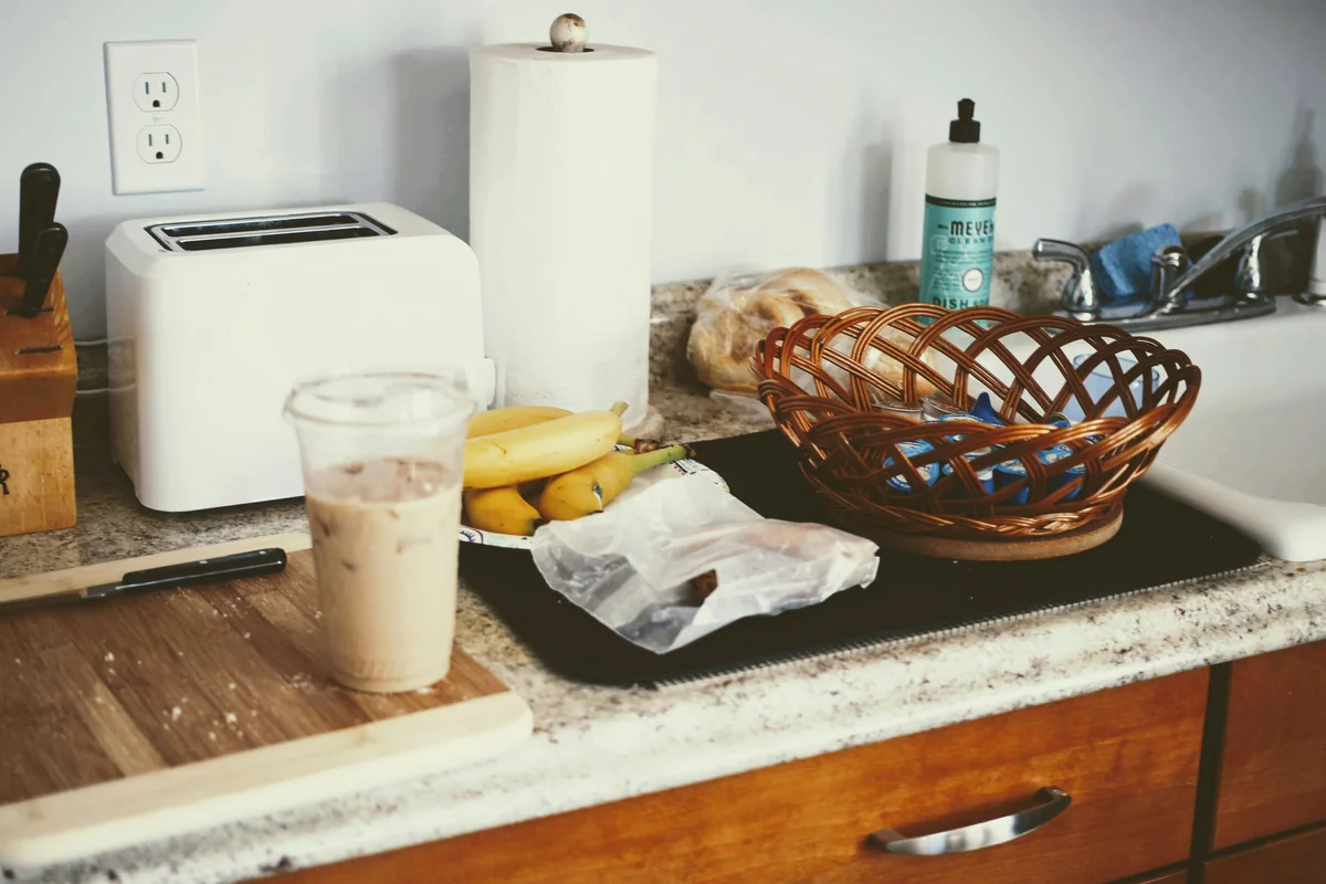 a kitchen counter with a basket of bananas and a basket of bread - underrated household items that will change your daily routine