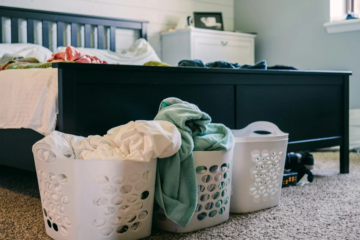 The never-ending baskets of laundry at the foot of our bed. Are they clean? I think so... give them a smell.... - underrated household items that will change your daily routine